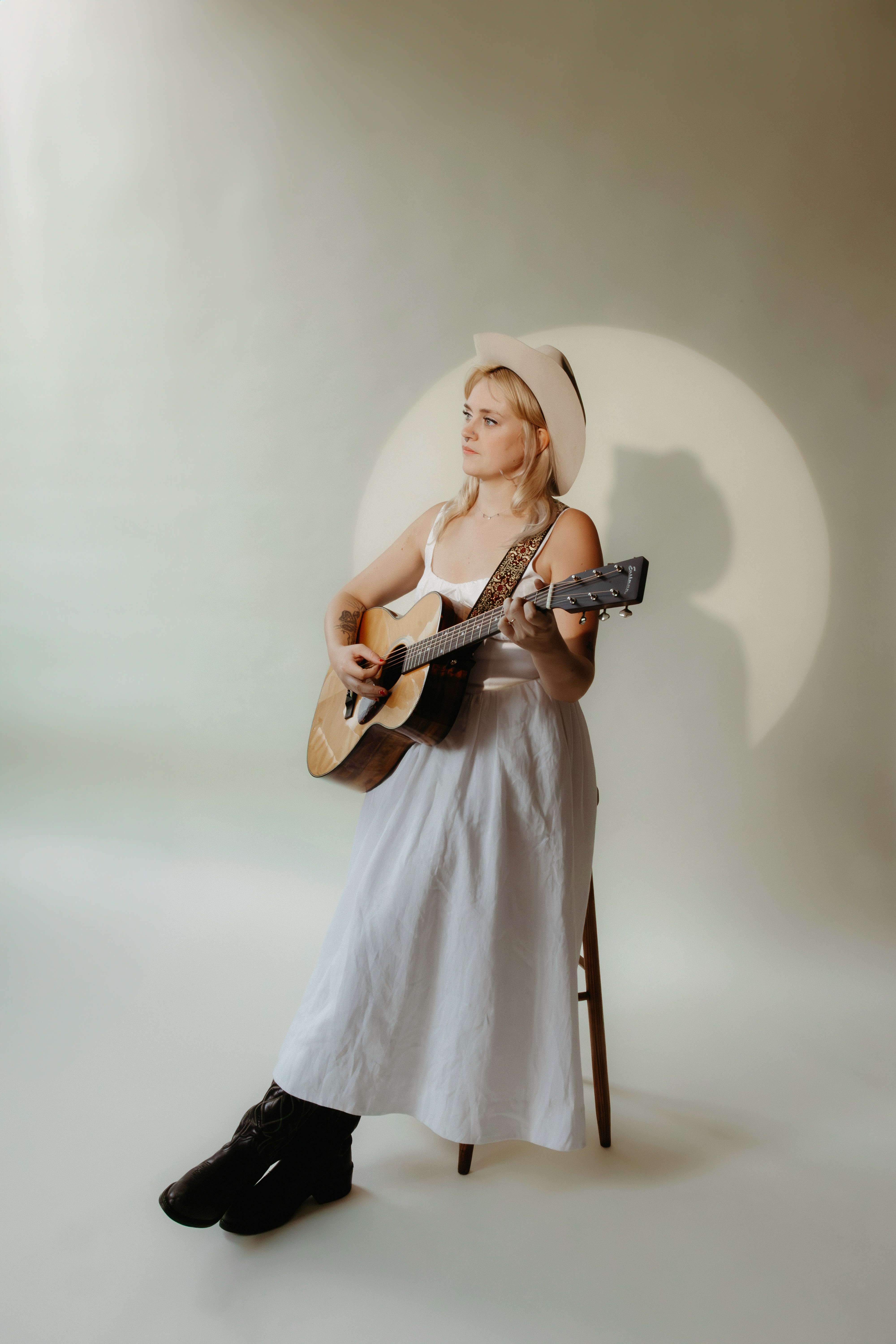 Artist Guinevere Goodwin playing a song in a commercial photoshoot