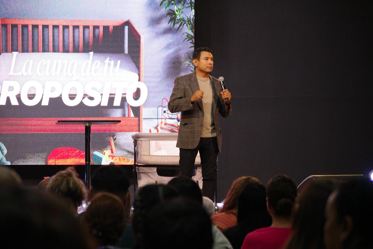 man in pink dress shirt wearing black sunglasses sitting on gray couch