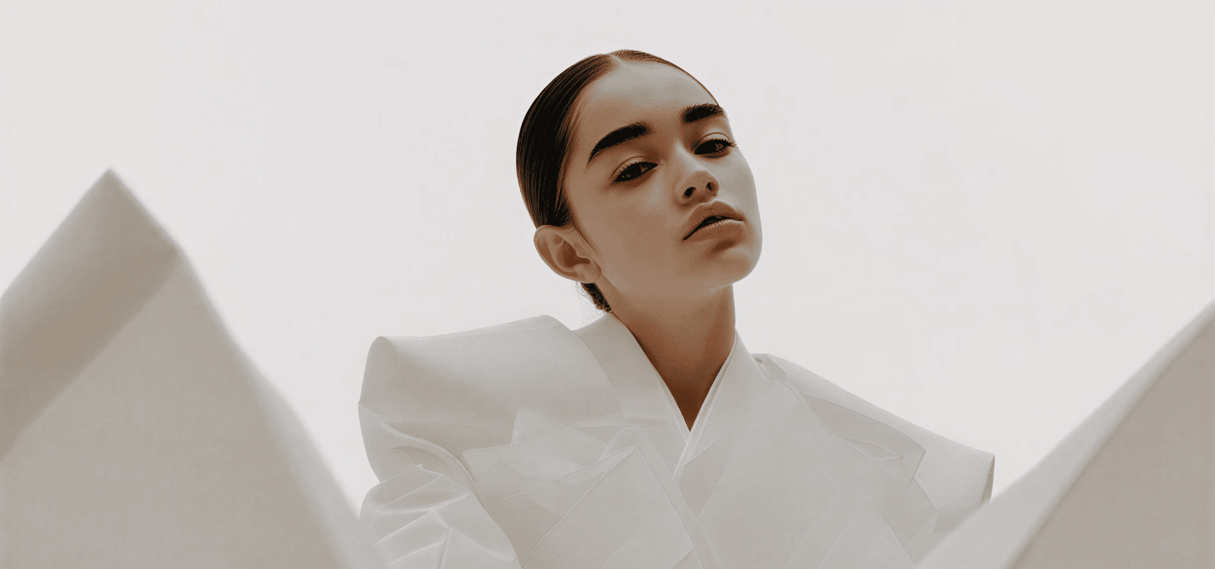 a woman holding a white sheet of paper