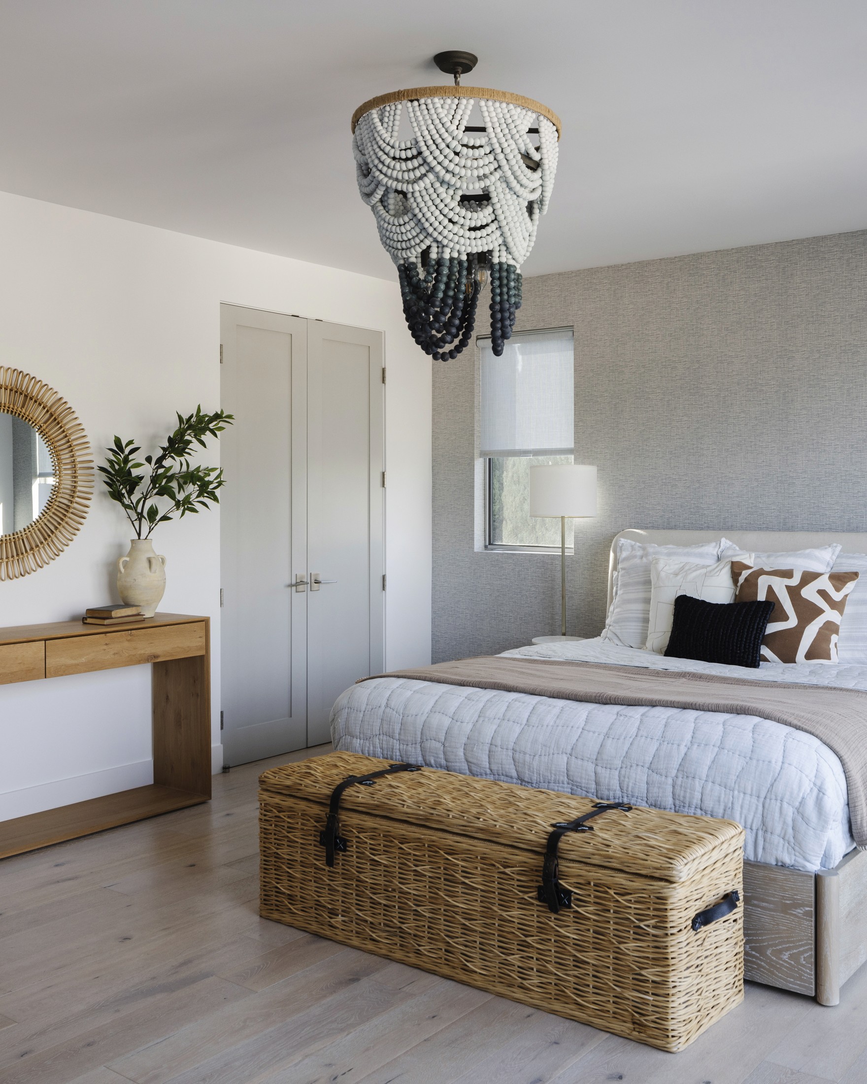 Primary bedroom view of bed, console table, accent chair, and large chandelier lighting