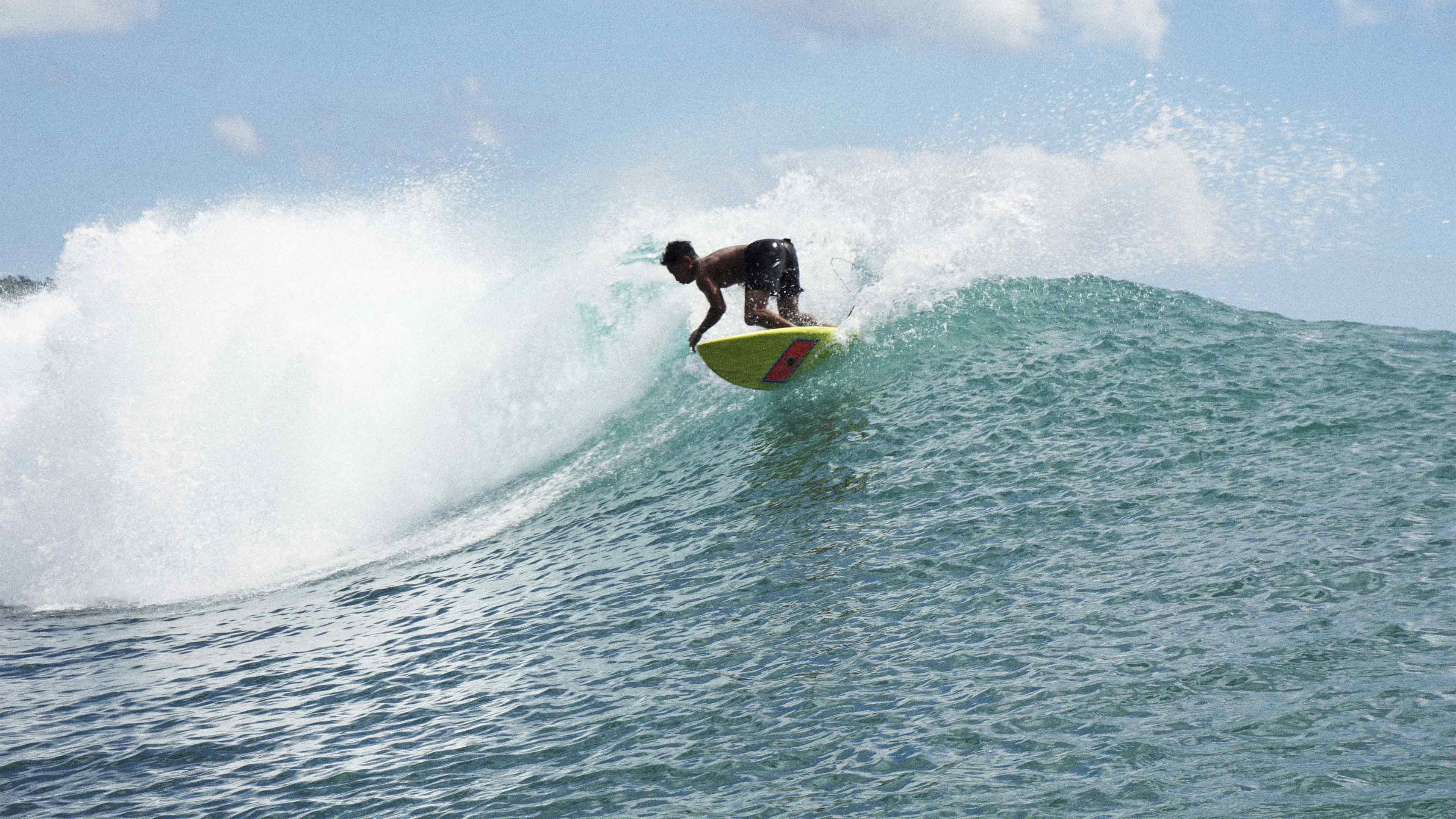 Man surfing at Bingin Beach Bali Indonesia