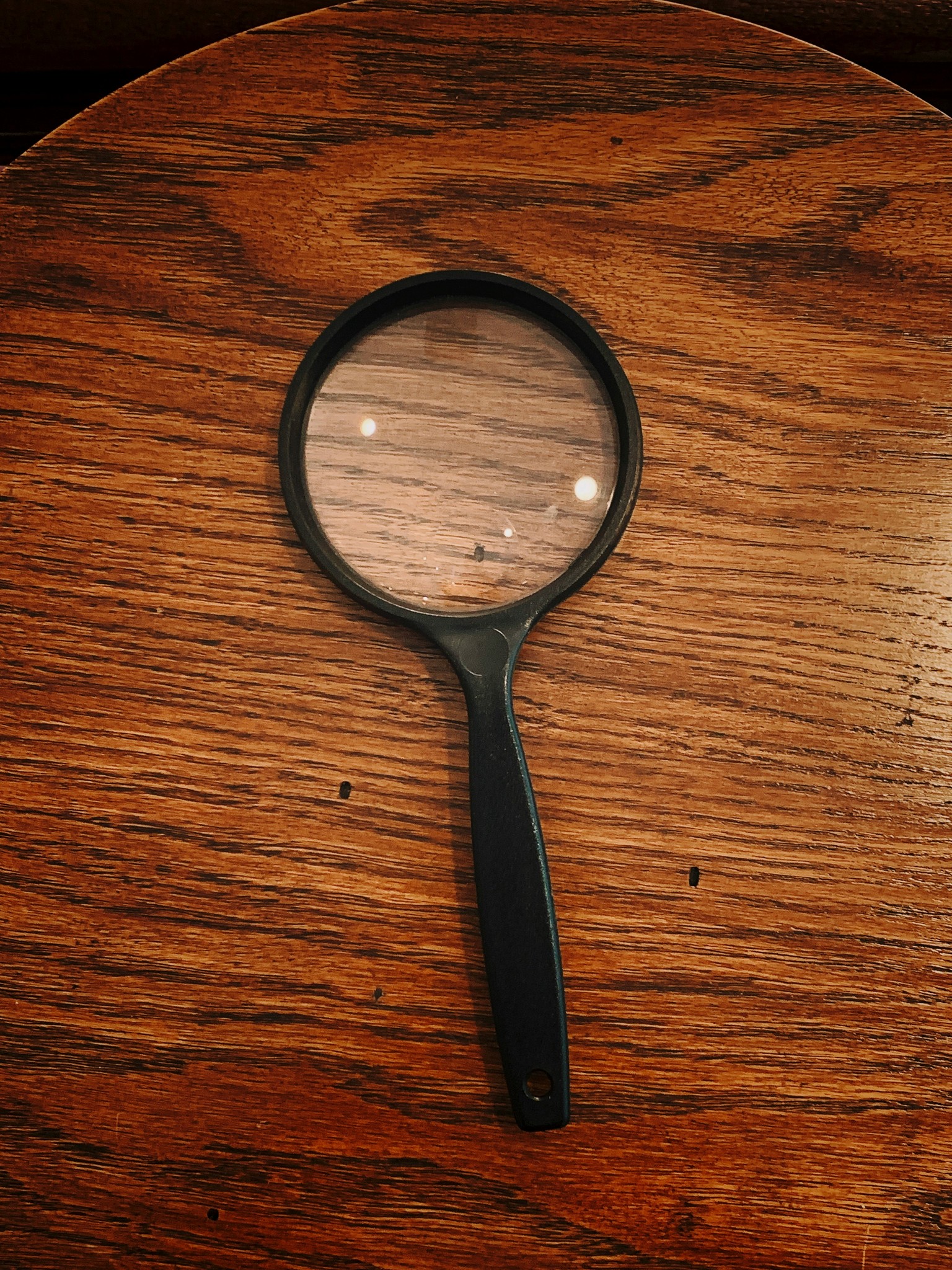 Stock photo: a magnifying lens lying on a table