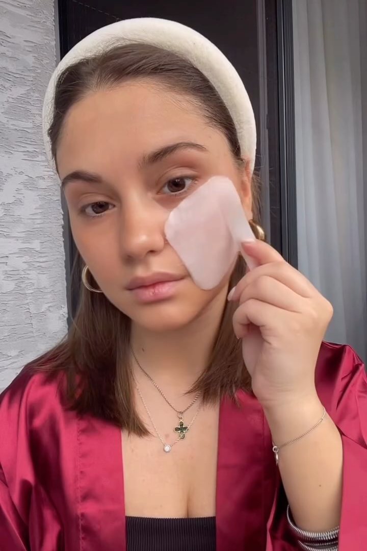 Option A: a creator holding a skincare pad against her cheek
