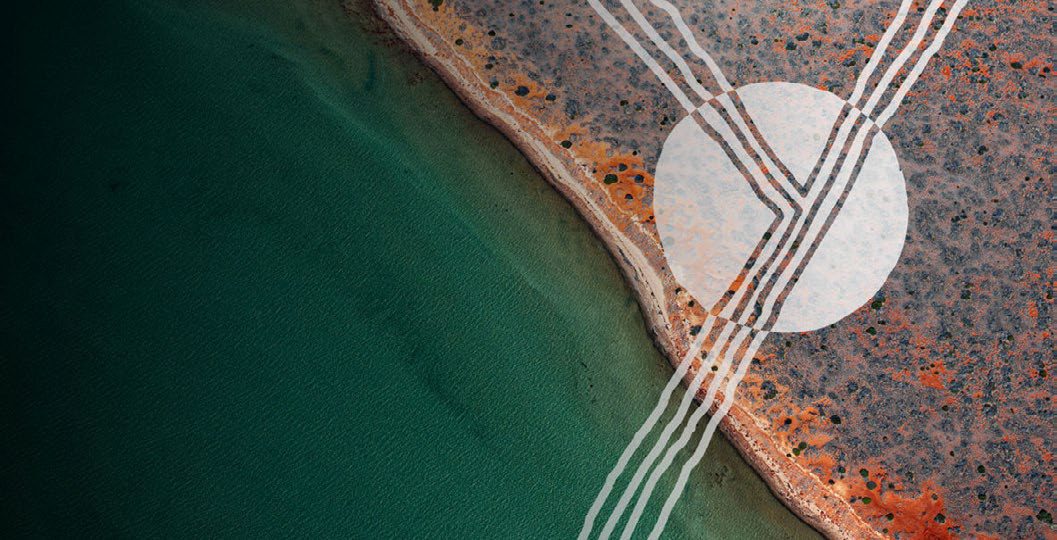 Aerial view of green water meeting red earth country