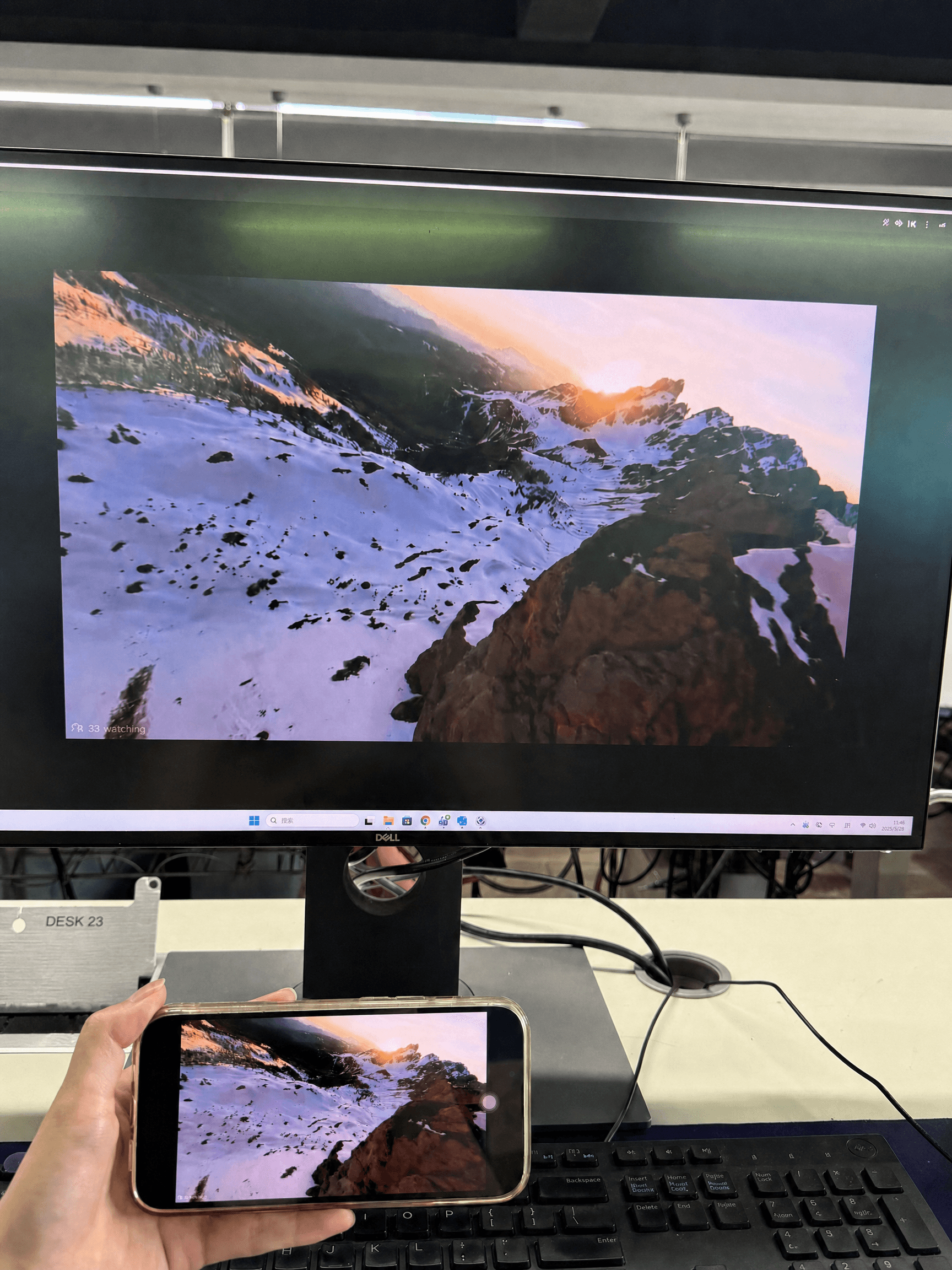 A real-world test photo of AirDroid Cast mirroring a phone screen to a laptop, captured during hands-on testing with visible device setup and mirrored display quality.