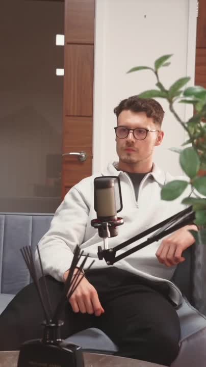 A young man in a navy blue zipper smiling