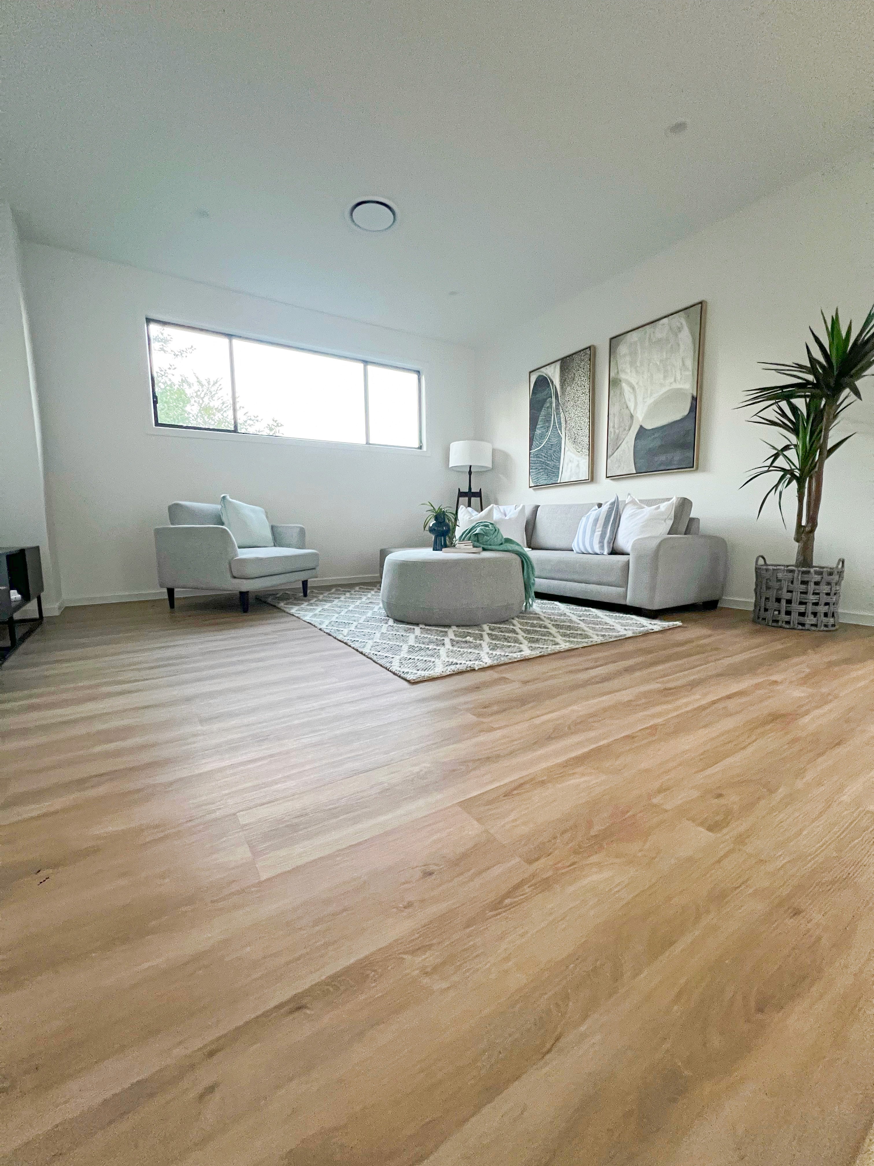 Open-plan Brisbane living room with hybrid flooring built for slip resistance and durability, ideal for busy households and Queensland’s changing weather.