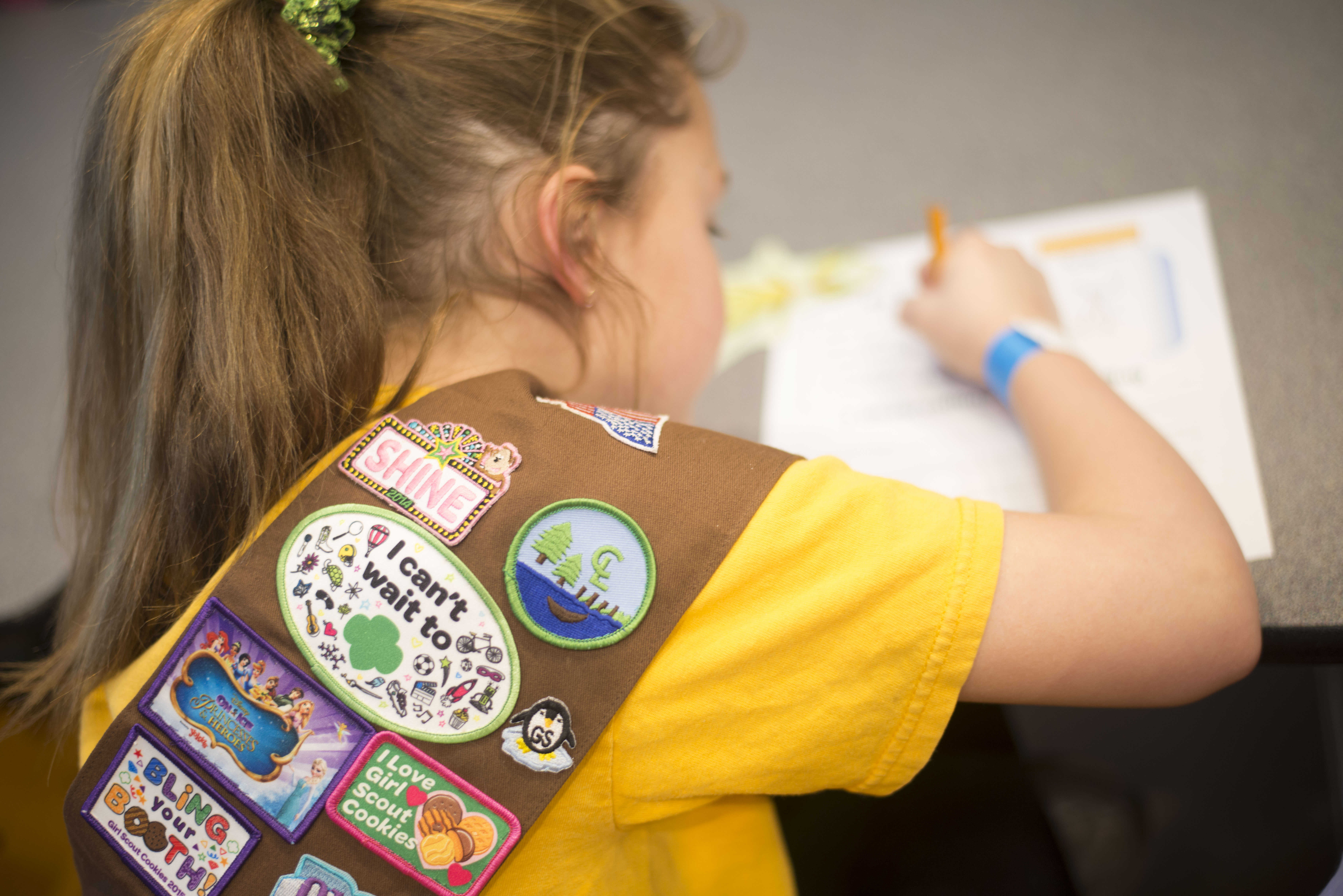 A girl scout works on a problem sheet.