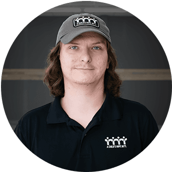 Headshot of Tyler Wiley, wearing a black A Child’s Hope Int’l shirt and hat. He is the Warehouse Coordinator.