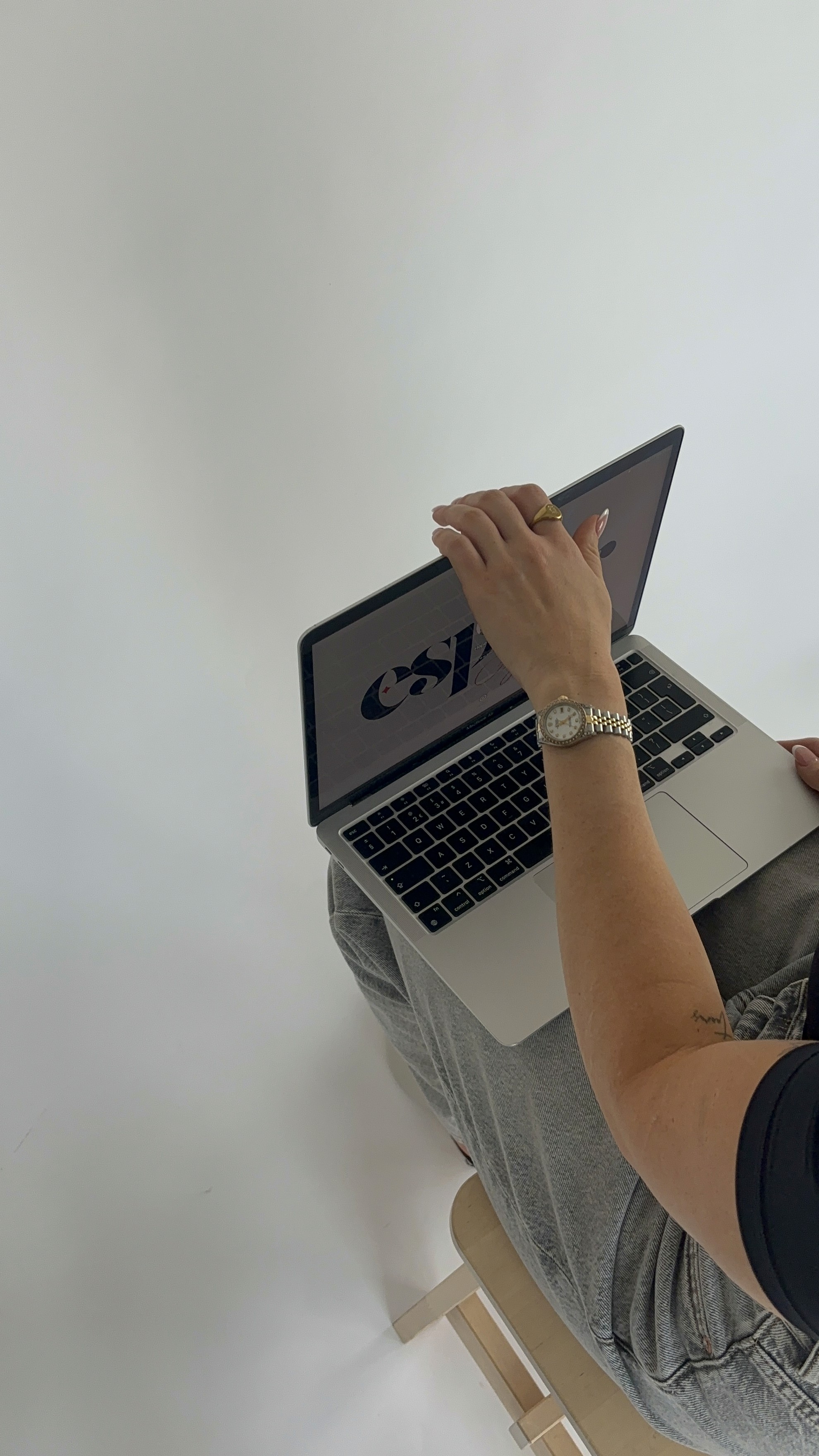 Photo of a hand slowly closing a laptop