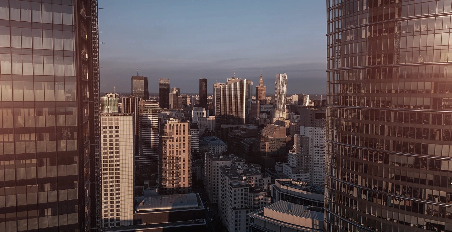 A city skyline with tall buildings, and many windows.