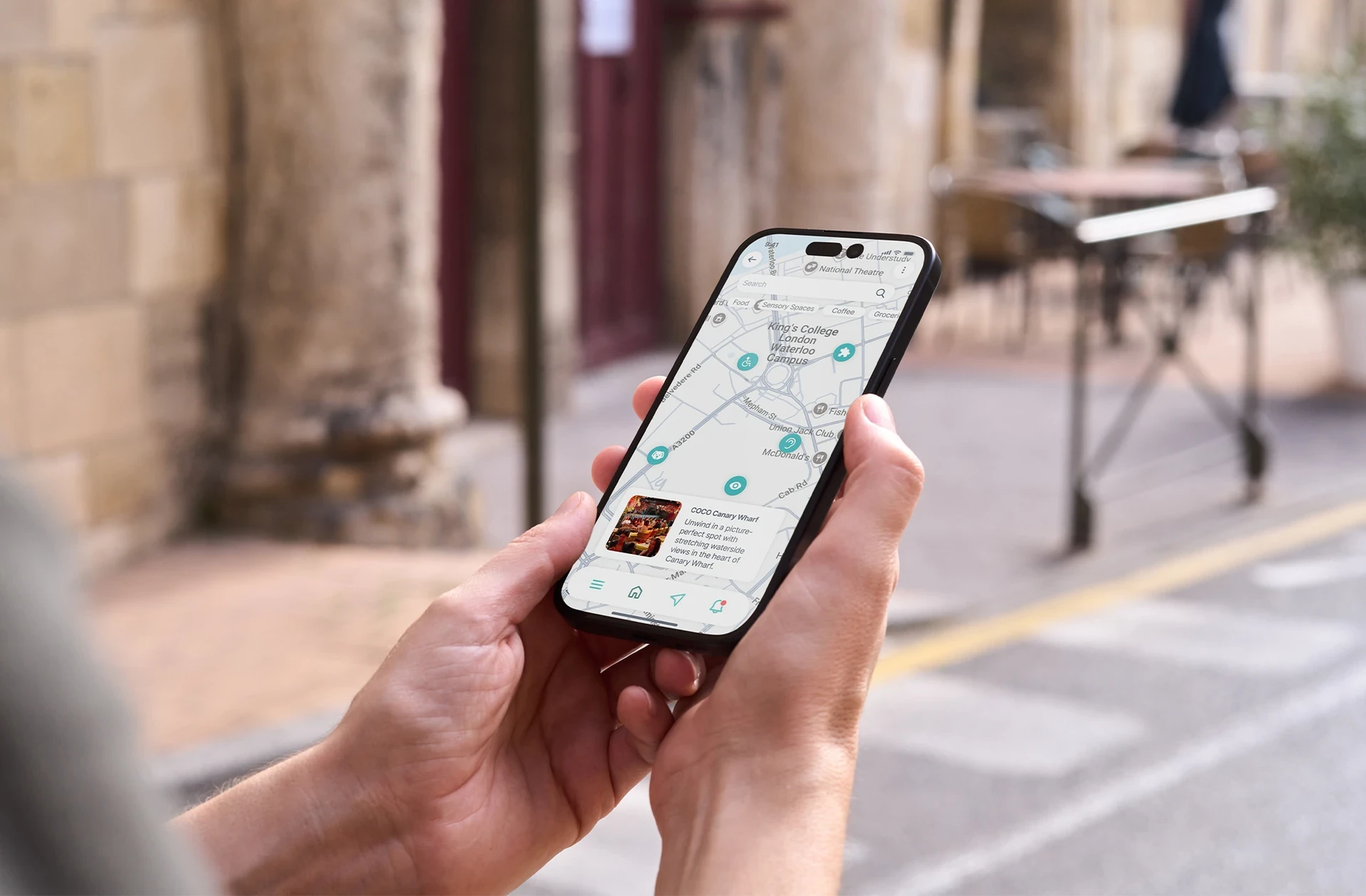 Person holding a phone displaying the Sensra app, illustrating user interaction and mobile interface.