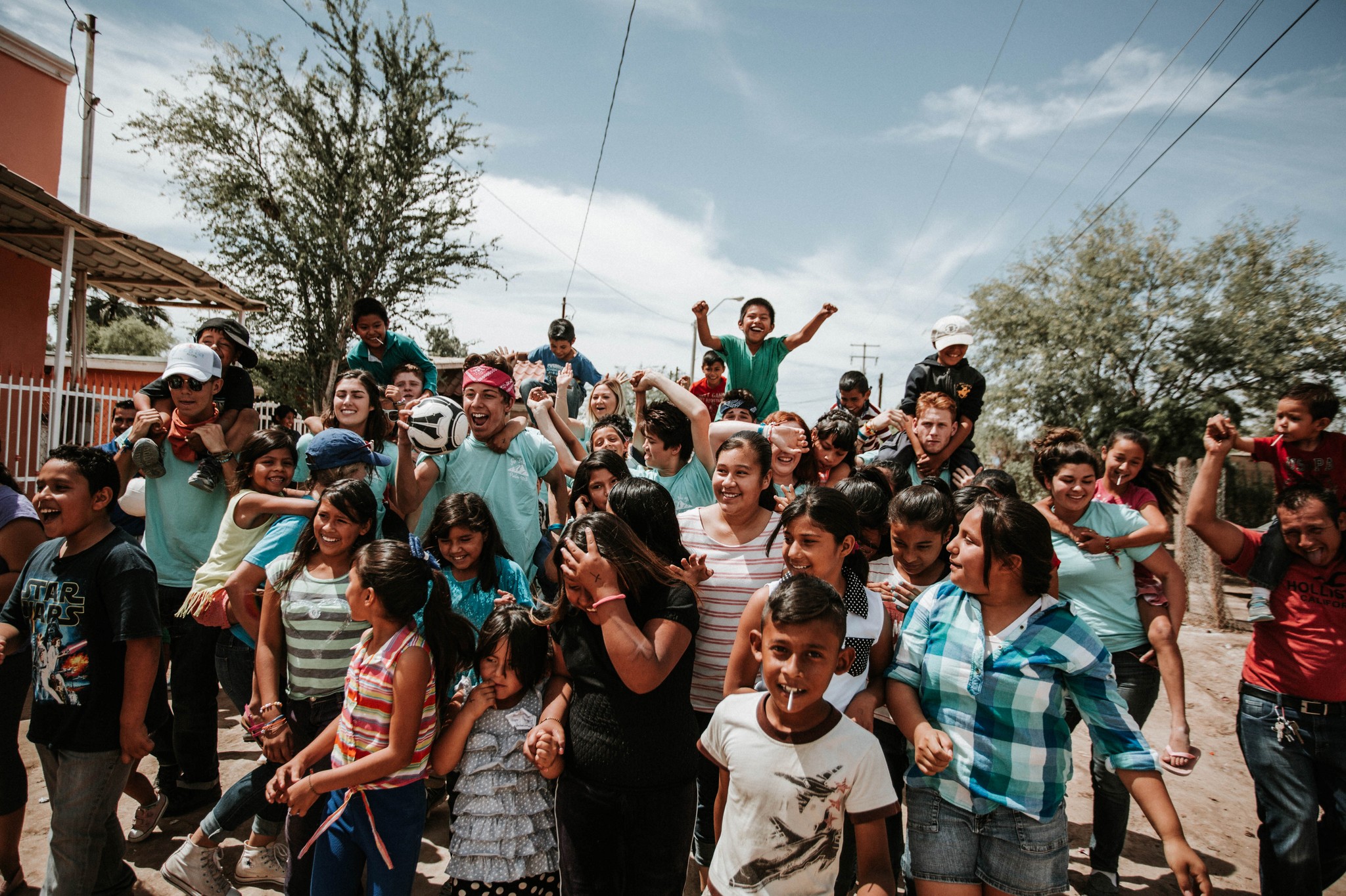 woman holding a phone and man looking at the phone. both are smiling