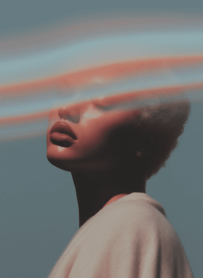 A person's portrait with closed eyes, a dreamy expression, and colorful streaks across their face. The background is a soft teal, creating a serene, ethereal mood.