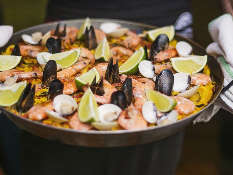 red train travelling near body of water