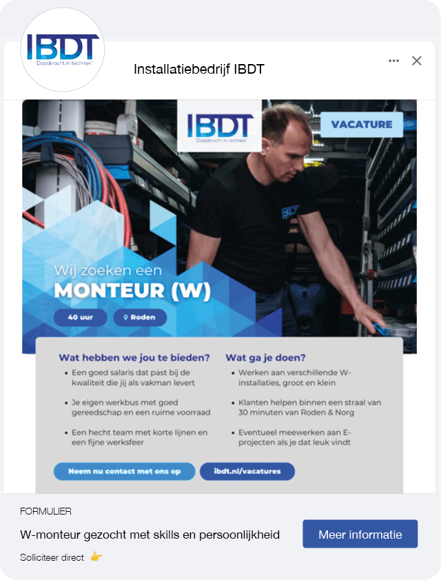 A dog sits on the grass, silhouetted against a beautiful sunset in the background.