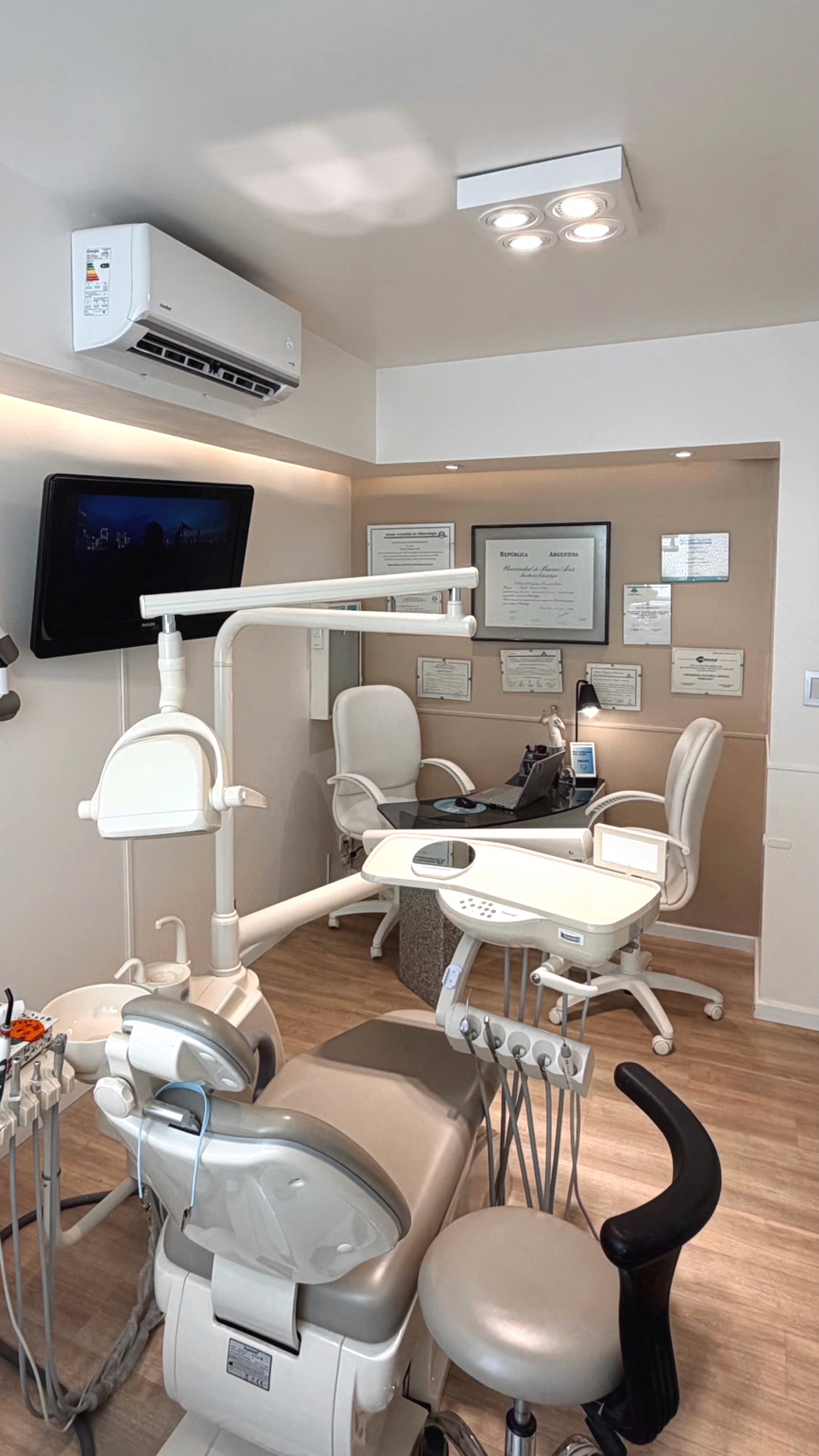 Dentist matching tooth shade using a dental color guide during treatment