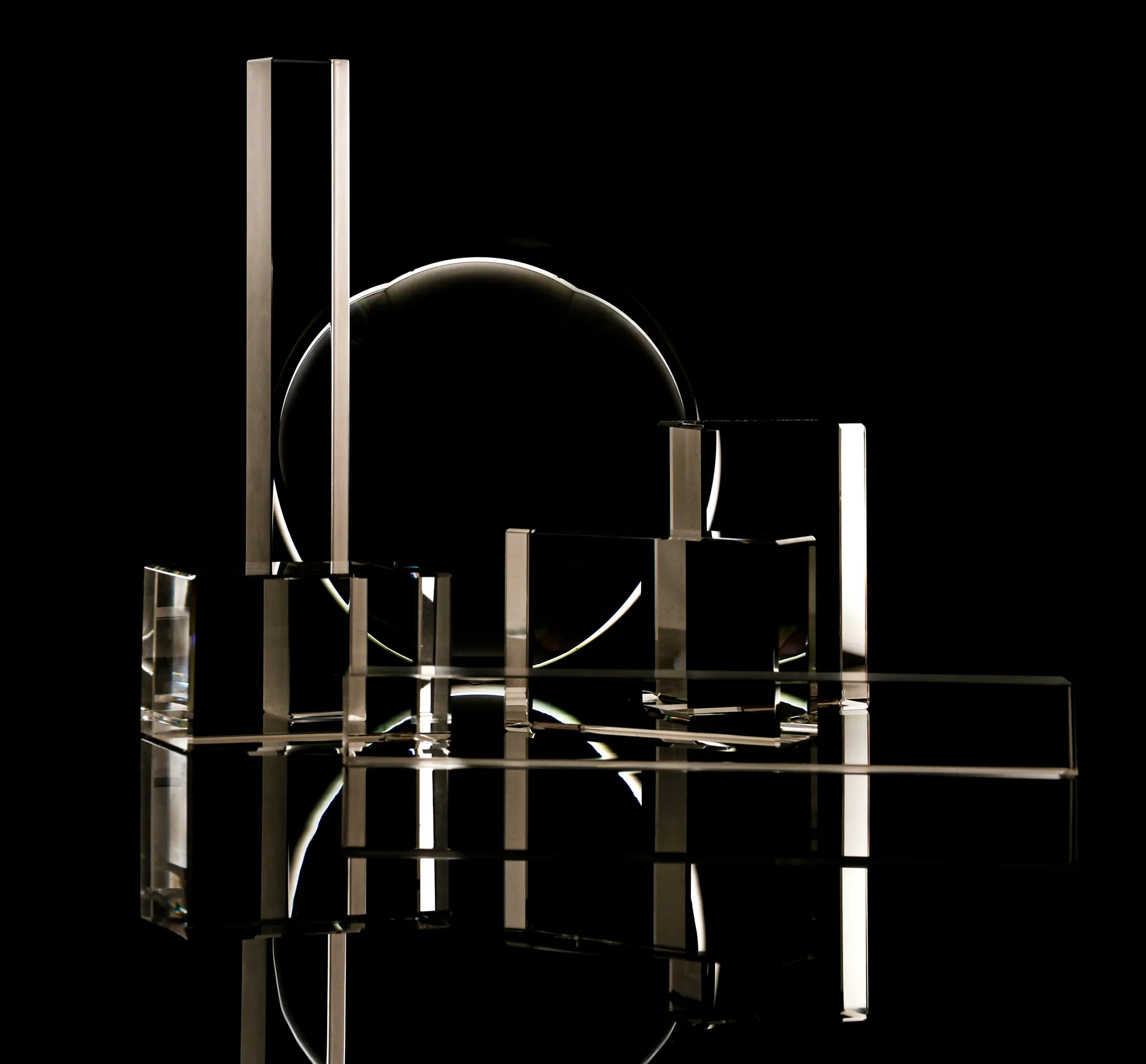 Glass shapes lit against black