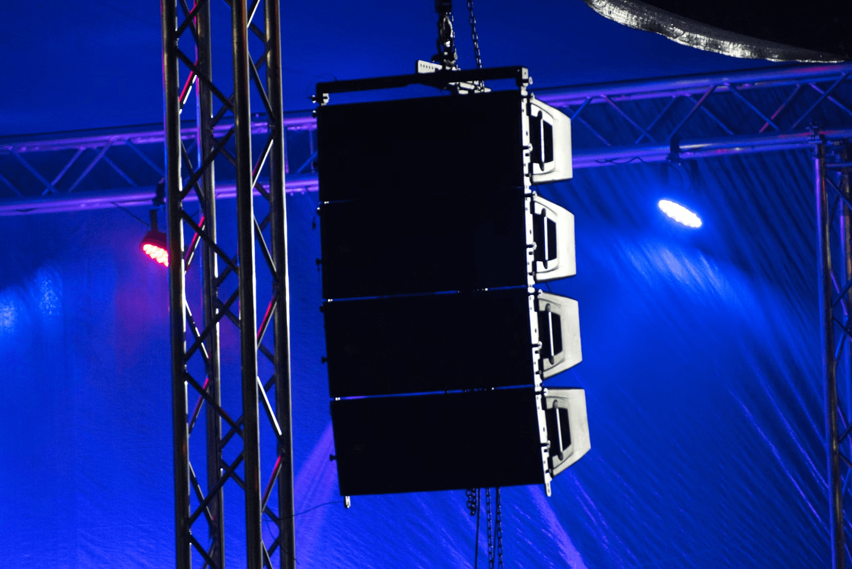 Line array speakers on stage lighting rig