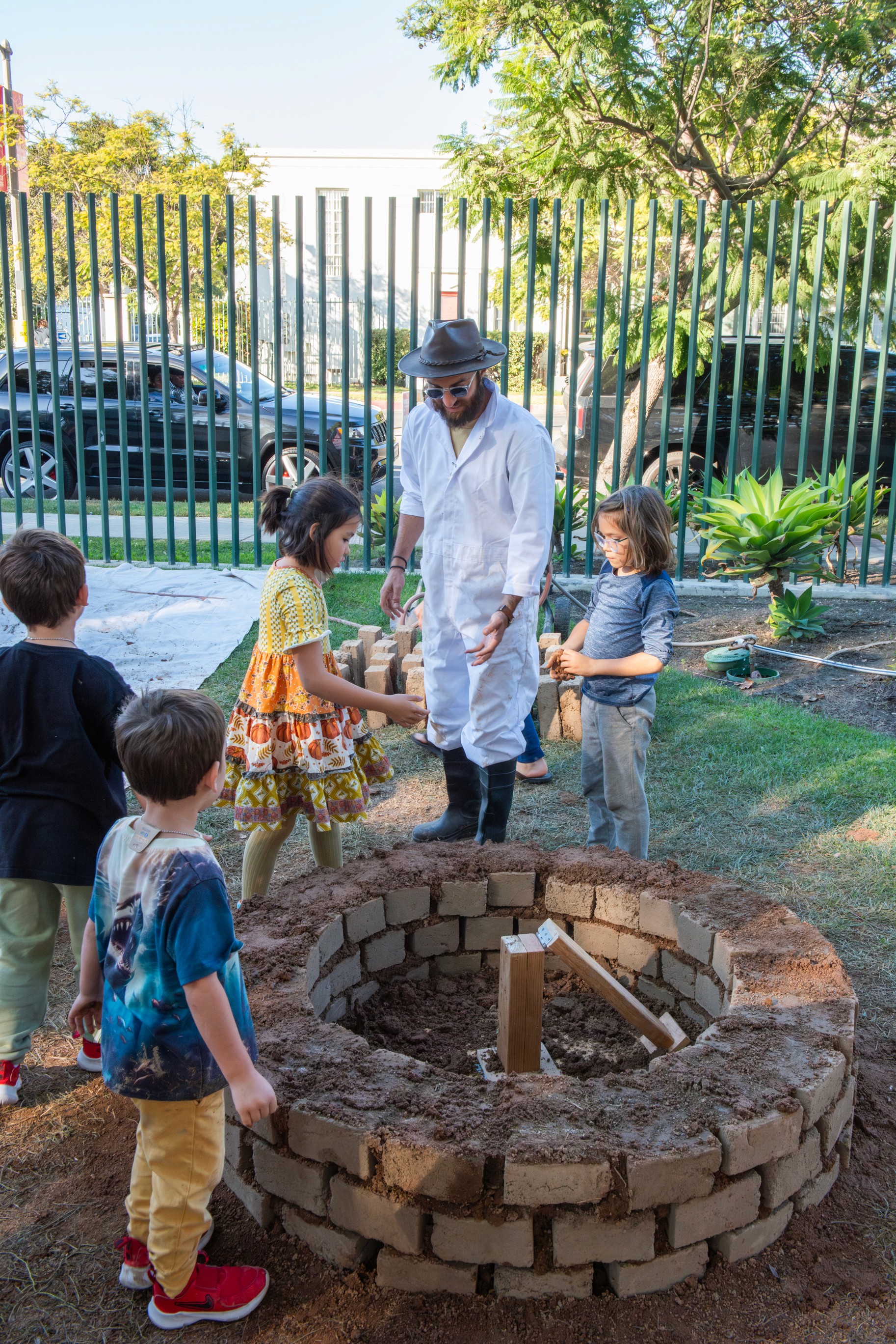  An exhibitor demonstrates a science concept to an engaged family at the community festival.