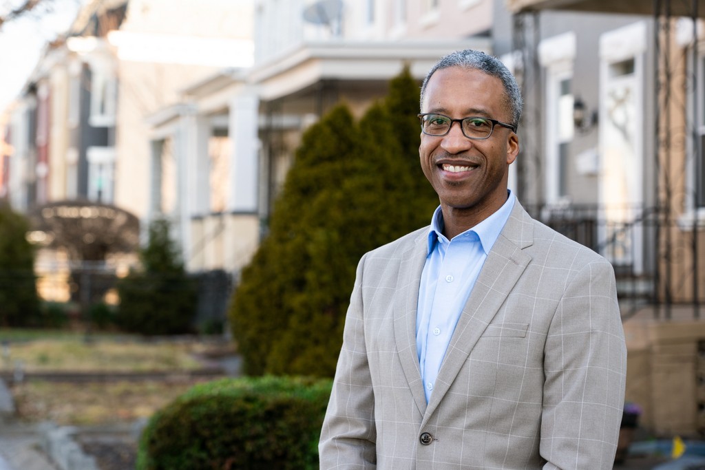 D.C. mayoral candidate Kenyan McDuffie standing in front of his D.C. childhood home.