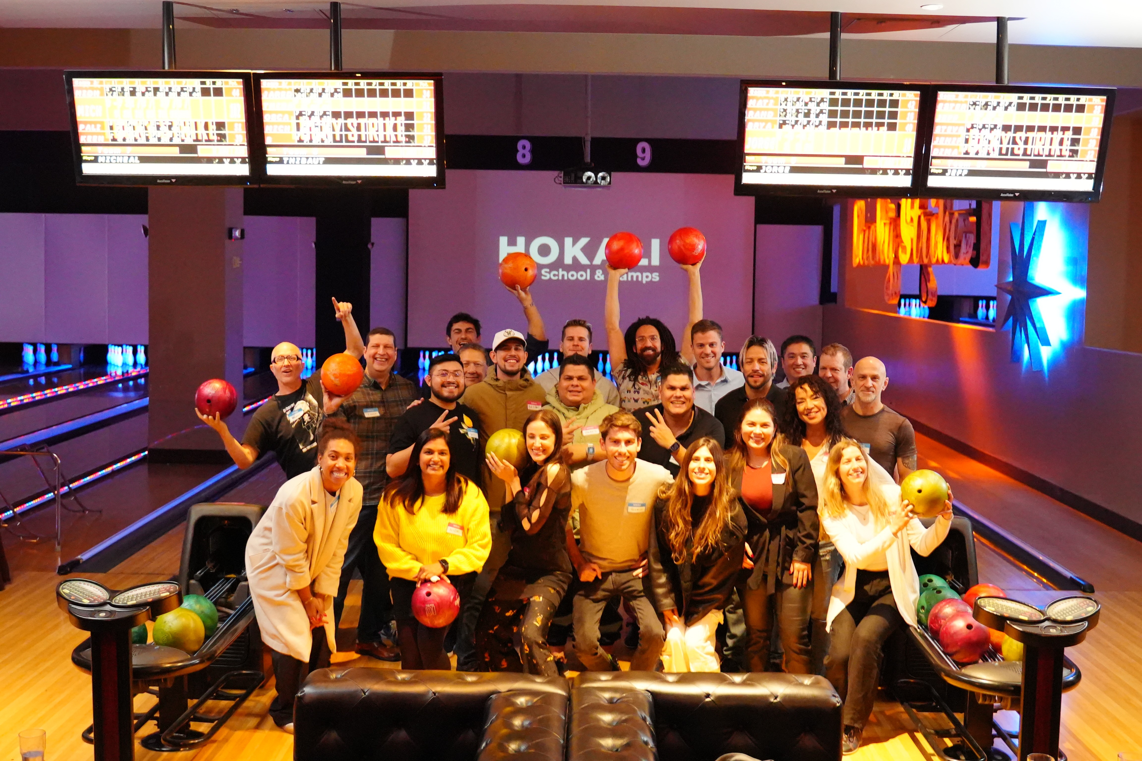 HOKALI educators participating in a team-building event at a bowling alley during a company gathering