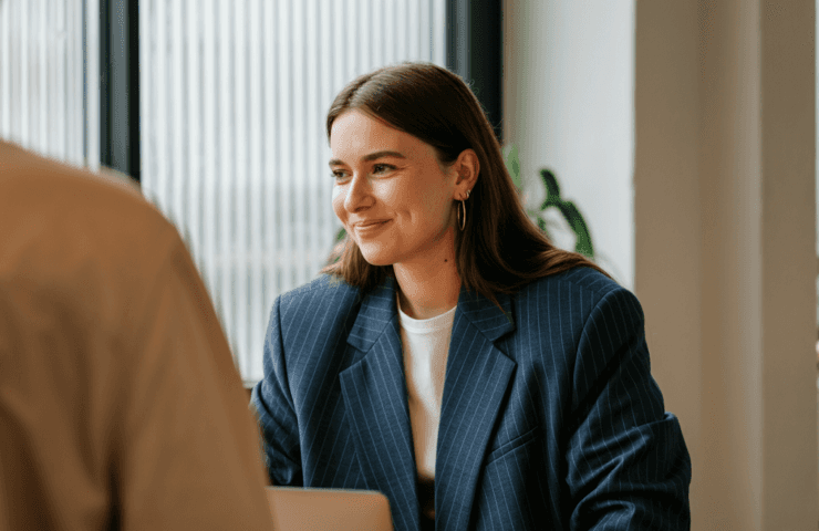 Smiling professional in a blue blazer during a meeting