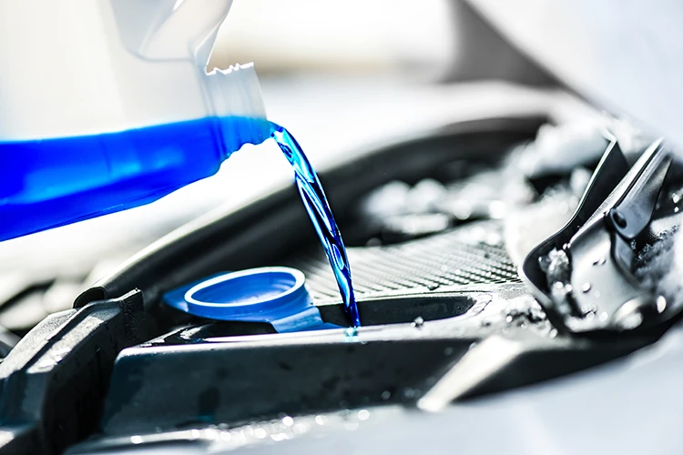 Blurred background image of an HVAC technician's hands carefully repairing the internal components of a heating unit.