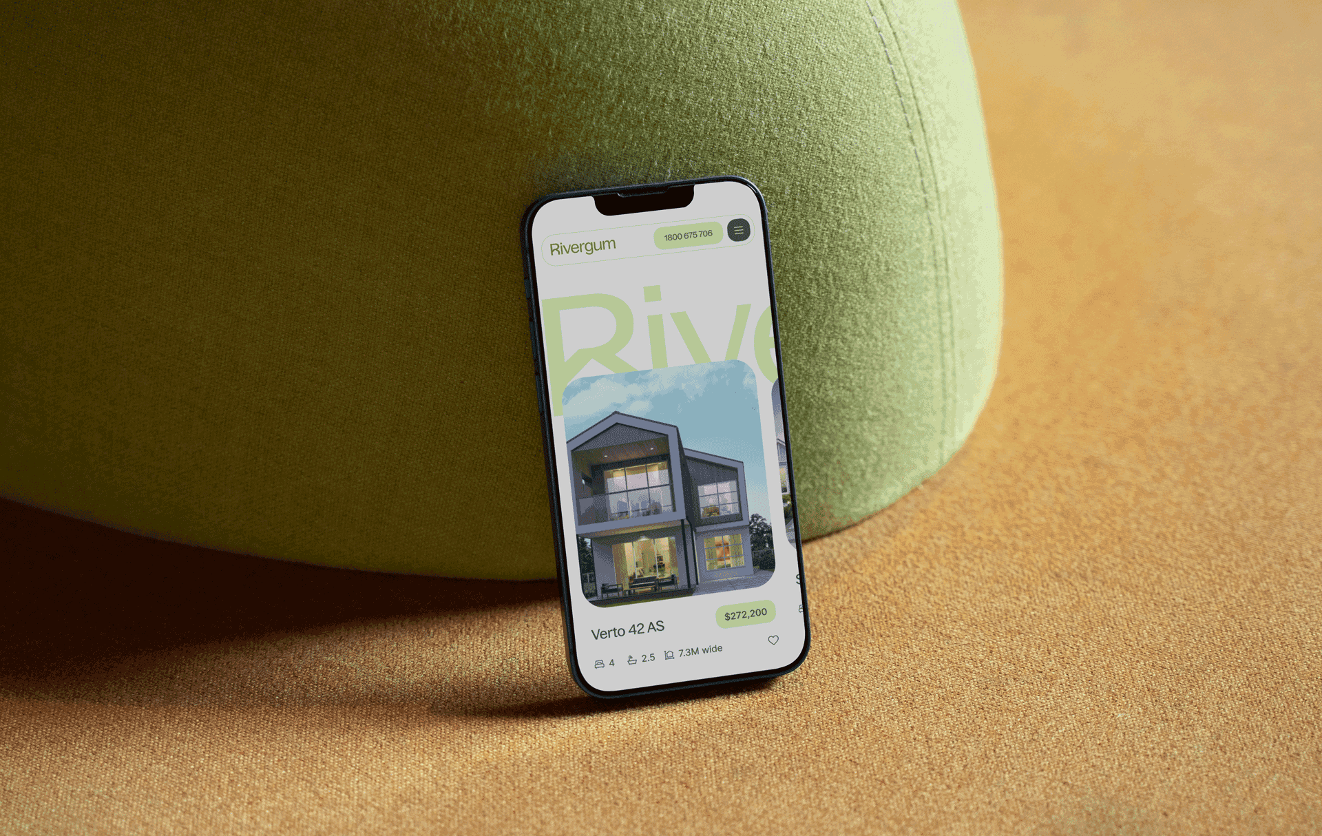 A phone mock-up, leaning on a green cushion.