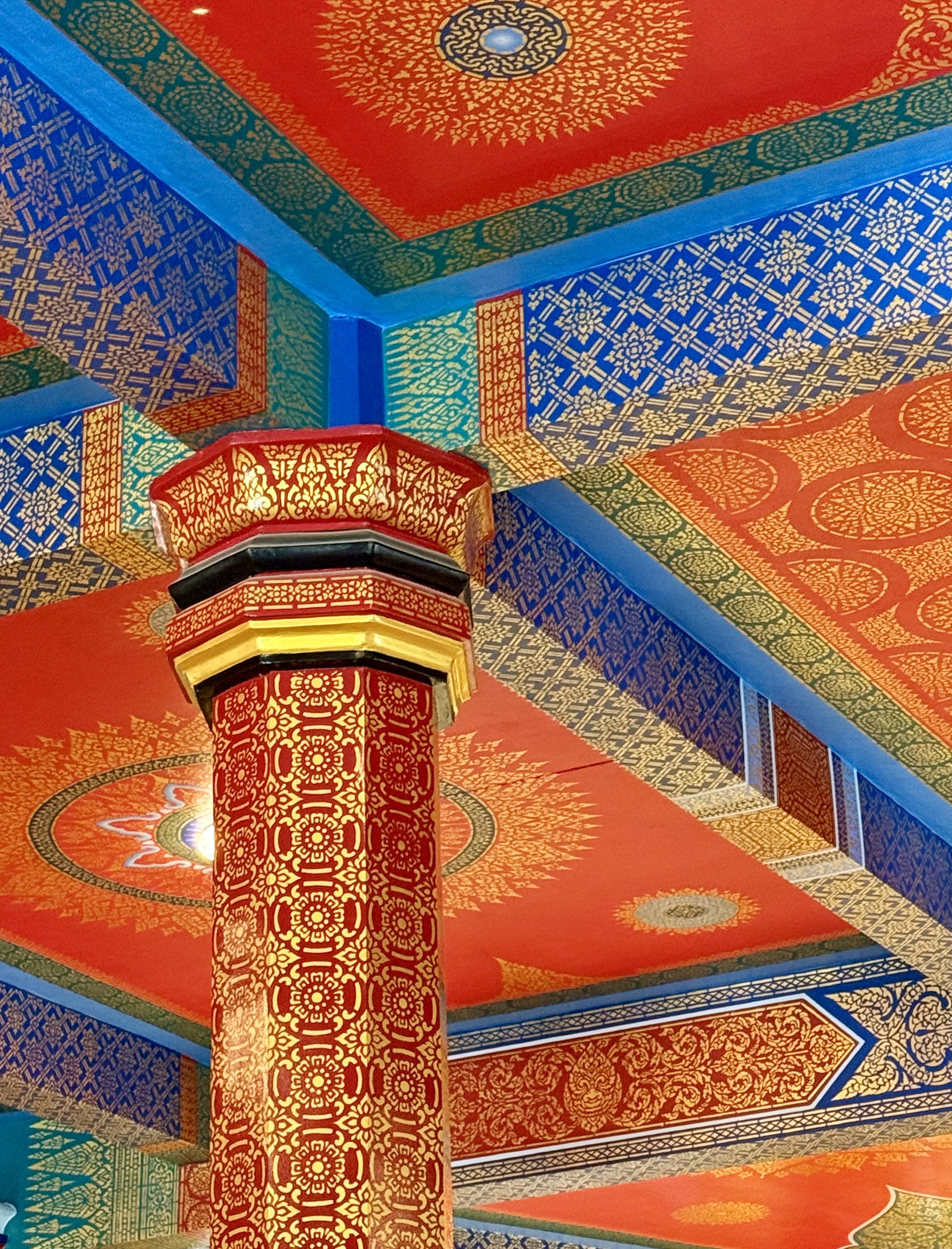 brown wooden lounger near body of water