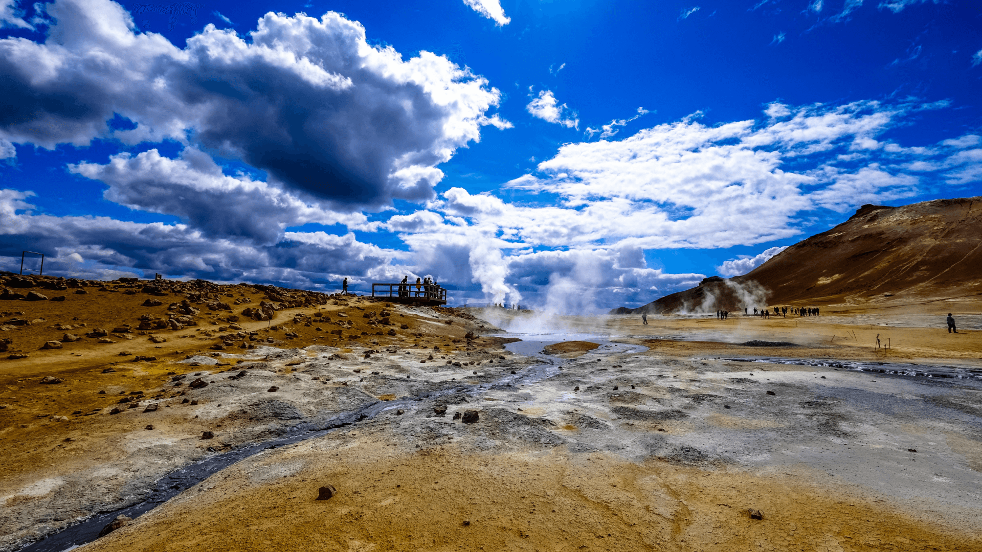 Steam rising from geothermal vents, illustrating real-world fluid dynamics and the hidden complexities that physics-informed AI can model