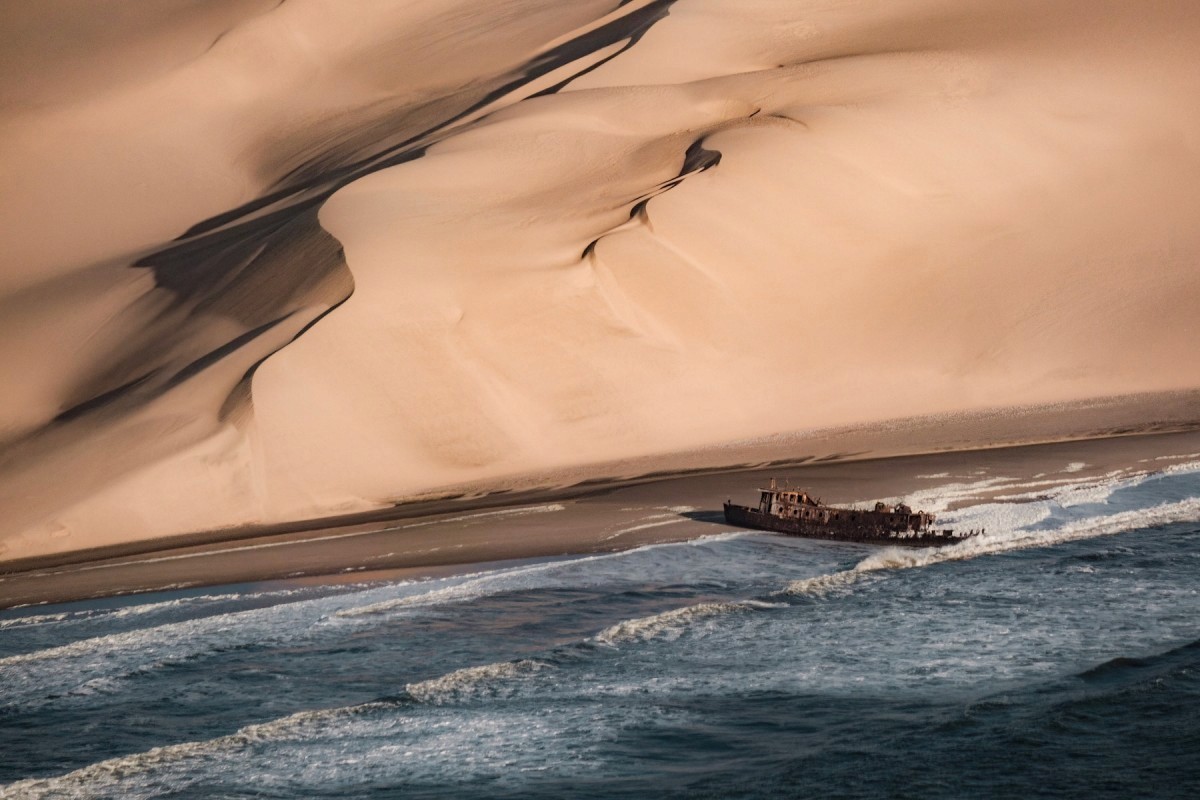 three brown wooden boat on blue lake water taken at daytime
