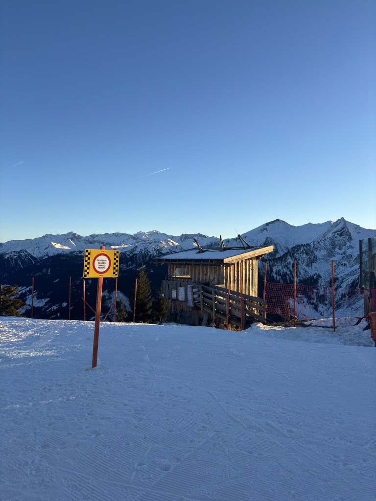 People playing soccer on a rooftop court surrounded by city buildings