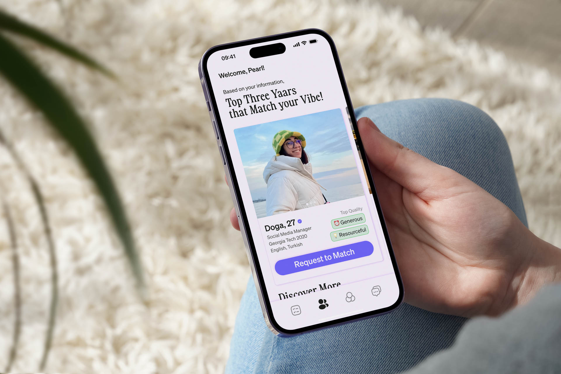 A hand holding a smartphone displays the Pearl app, featuring a photo of a woman in a white jacket and green beanie, with text indicating “Top Three Years That Match your Vibe!” The interface includes options like “Doga. 27”, “Social Media Manager”, and a purple button labeled “Request to Match”.