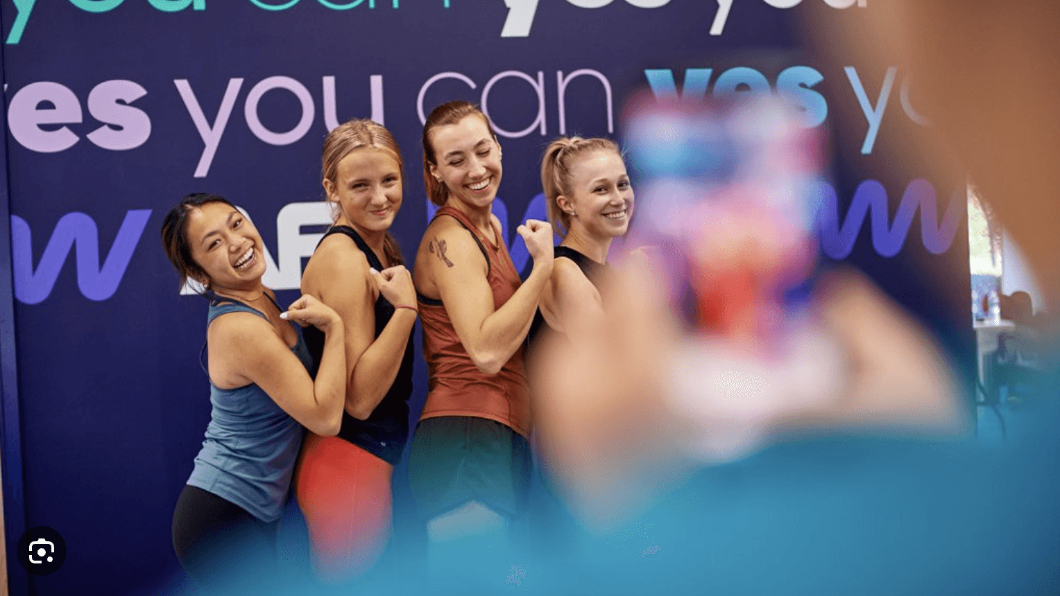 A group of men standing around each other in a room