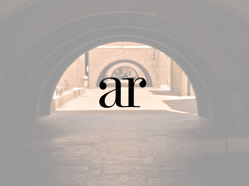 Rural landscape with a small building and trees.