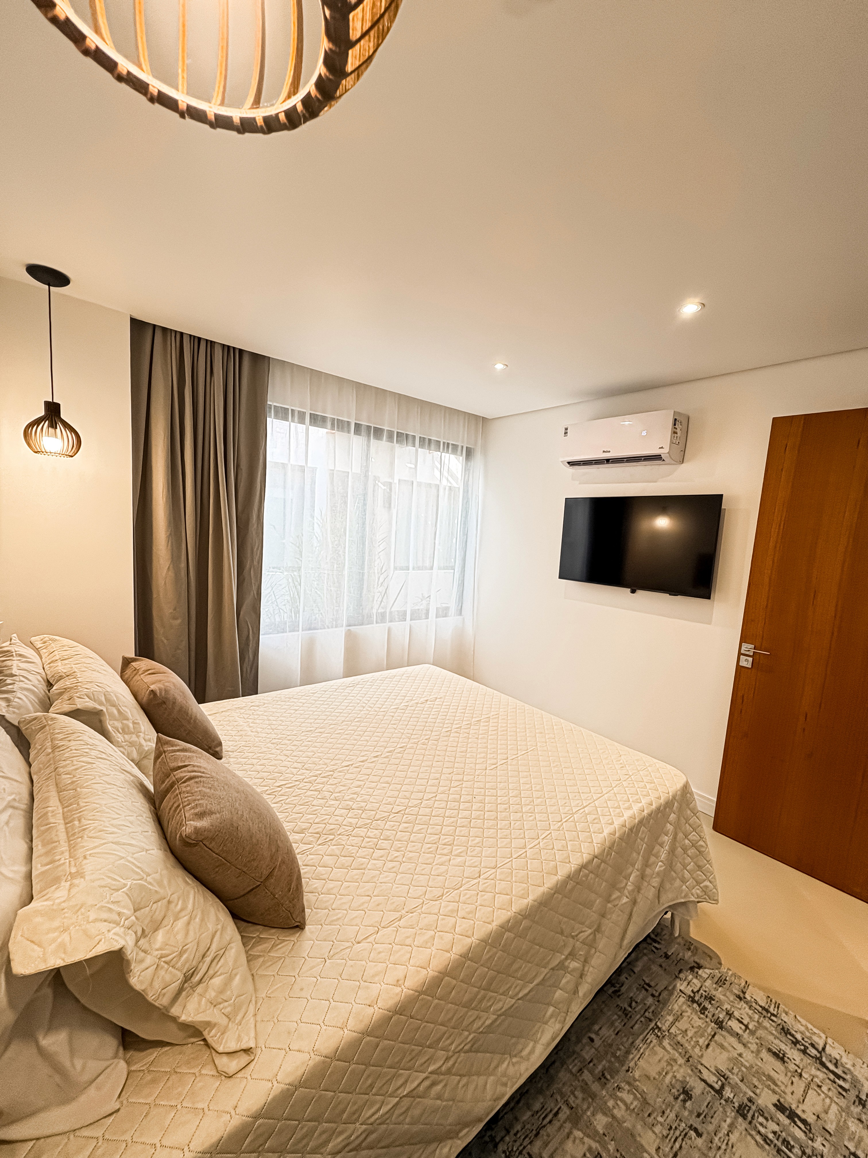 breakfast tray on bed, light blanket, and garden glimpses through sliding doors