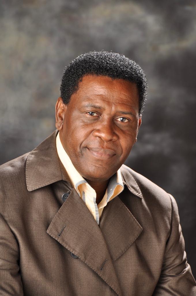 Group of men standing with Sufboard