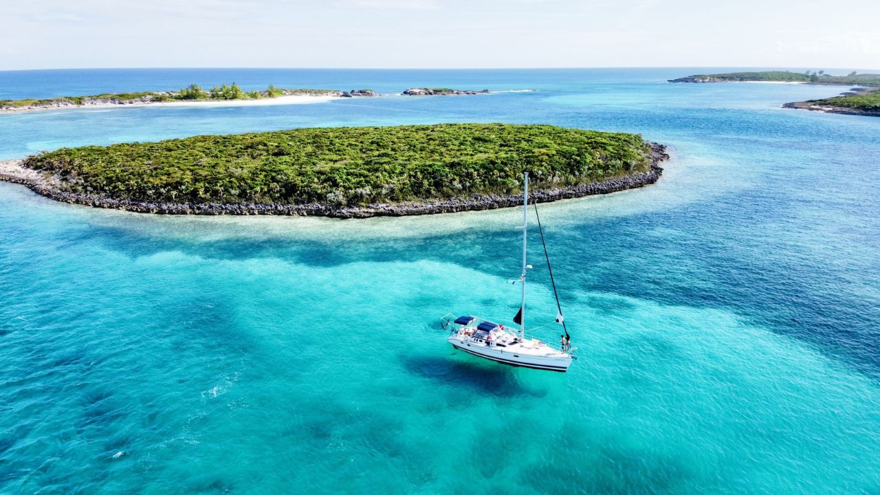 Sailing Afterglow’s sailboat anchored off an island in the Eastern Caribbean