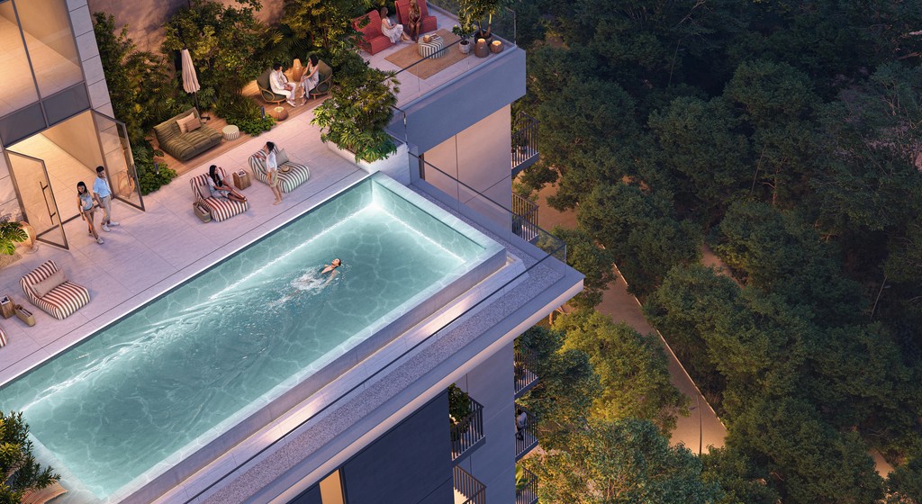A rooftop pool at Distrikt Ghaf Woods, with people relaxing and socializing around the water.