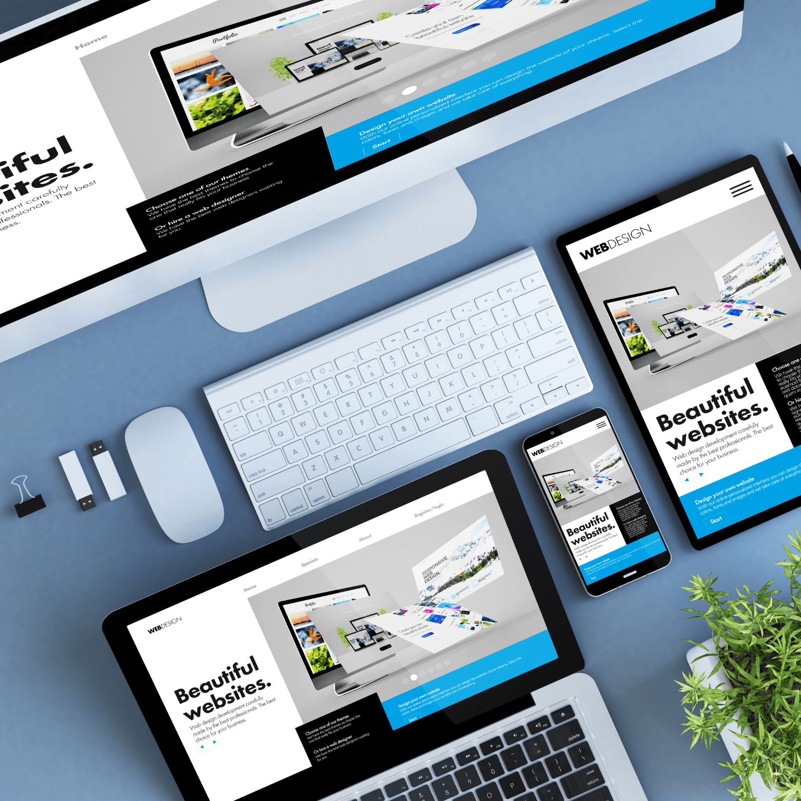 A Image of a desk taken from above shwoing a monitor, a laptop, a mobile phone, a tablet, a mouse and a keyboard.