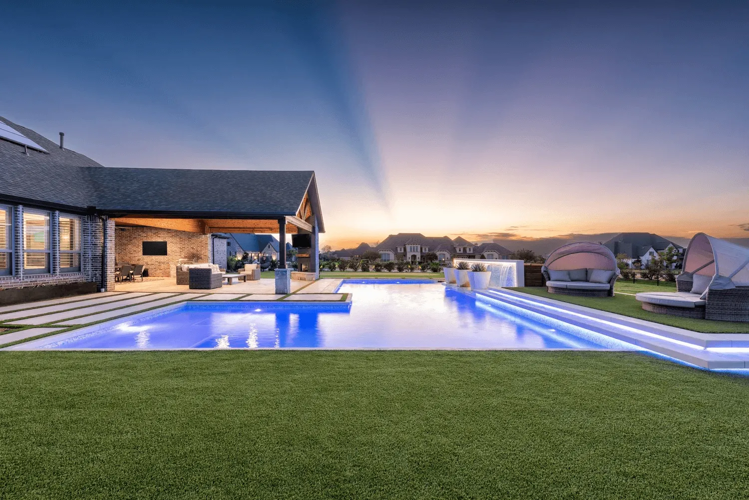 Modern pool with integrated lighting in tranquil open backyard setting Dallas luxury landscape