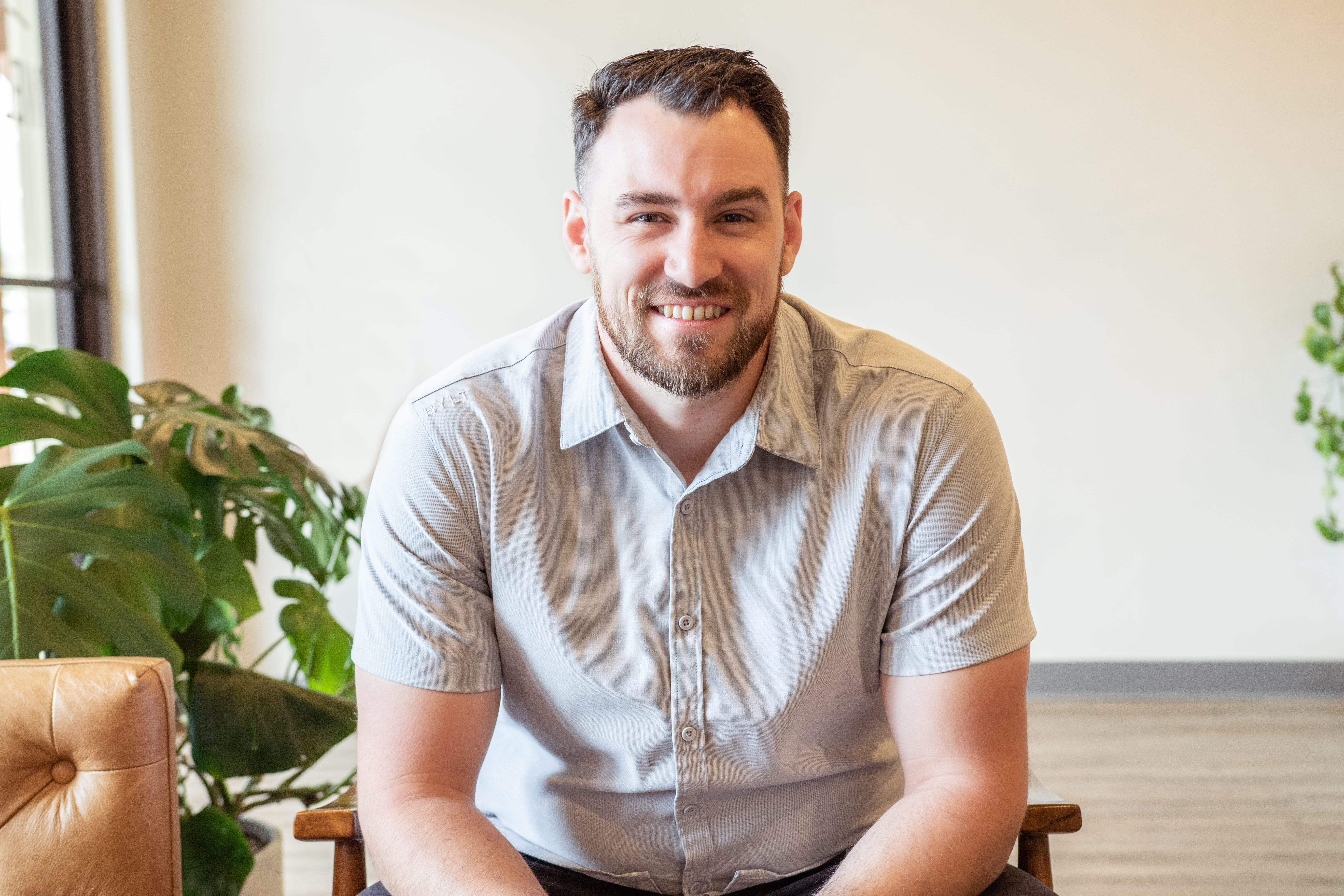 A headshot of a smiling male doctor.