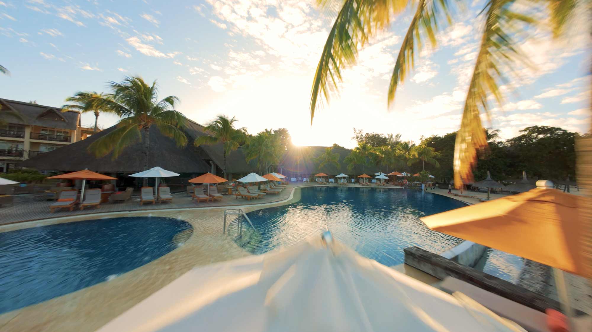 Sunlit tropical resort pool, filmproduction ad for a hotel in mauritius