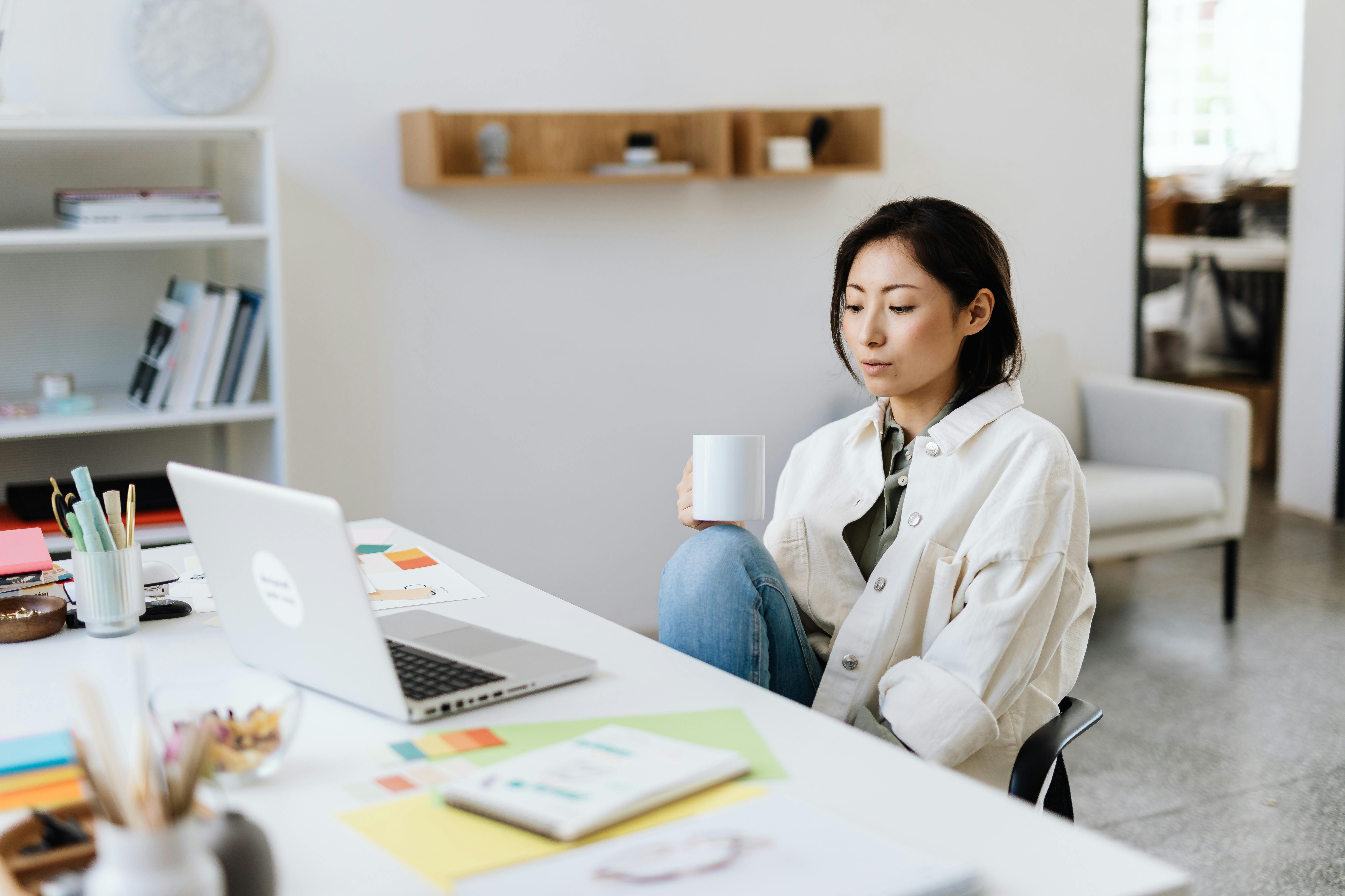 Woman reading on laptop if do companies pay for leads and how to maximize ROI with smart strategies