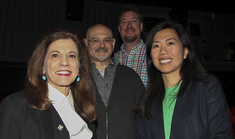 A photo of a group of people smiling.