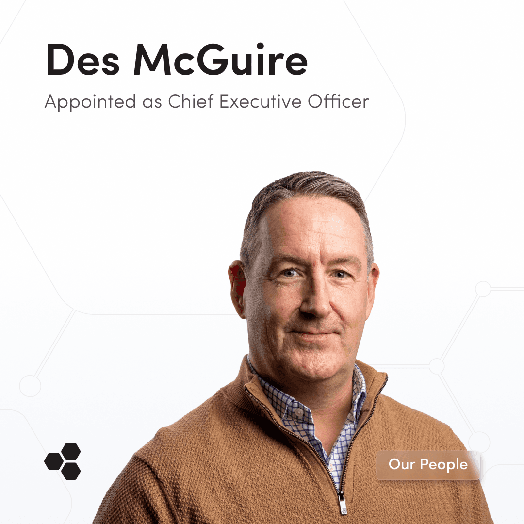 Des McGuire, newly appointed Chief Executive Officer, shown wearing a brown zip-up sweater and checkered shirt, facing the camera with a calm demeanor. The image highlights his recent appointment, featuring a button to ‘Read the release.’