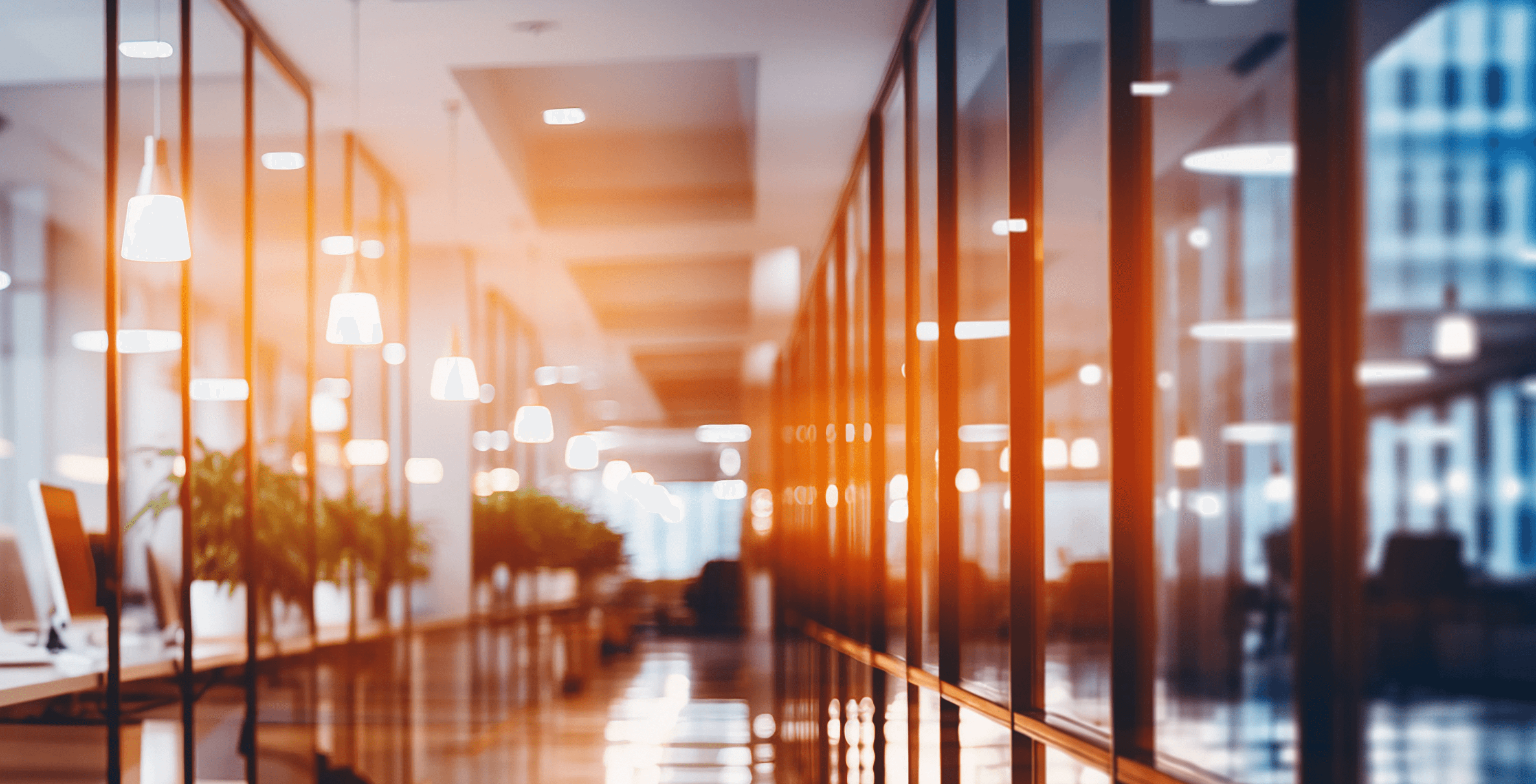 KL homepage hero – defocused glass-walled office, cool neutral tones