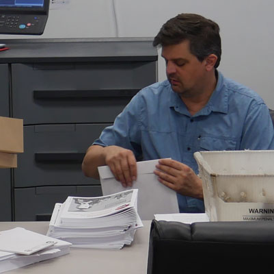 an employee completing their direct mail work