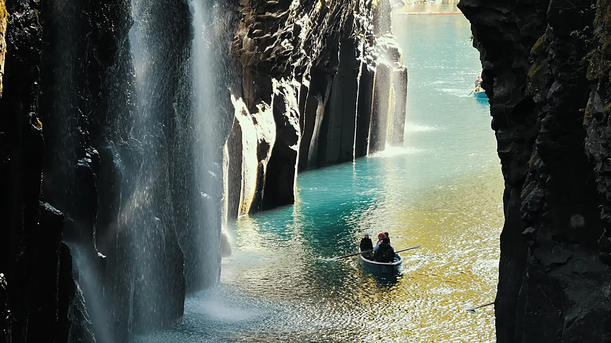 A rowboat below the falls in Takachiho Gorge, Miyazaki, a long day trip from Kurokawa Onsen